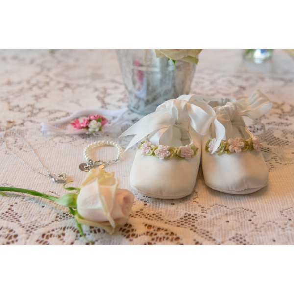 Baby’s baptism items on lace tablecloth